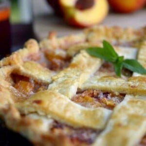 A close up of a peach pie.