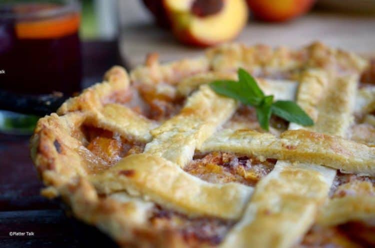 A close up of a peach pie.