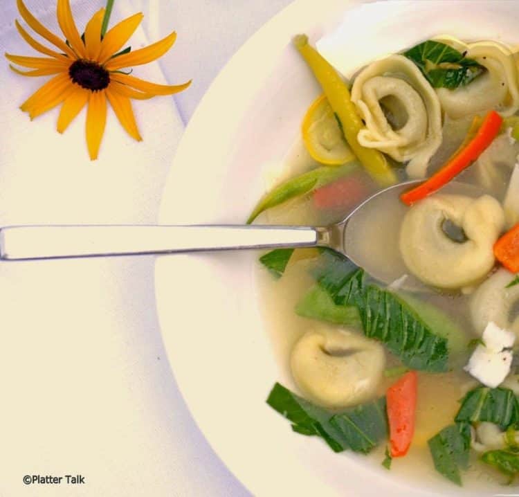 A bowl of soup, with Tortellini.