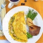 A plate with an omelette on it.