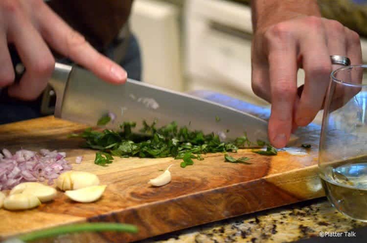 A person cutting basil.