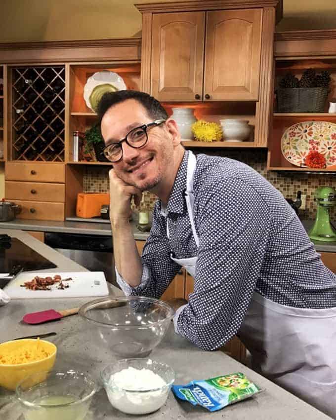 Man standing in a kitchrn.