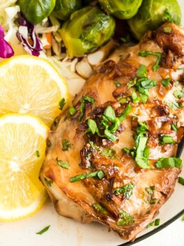 A plate of haddock with Brussels sprouts and lemon slices