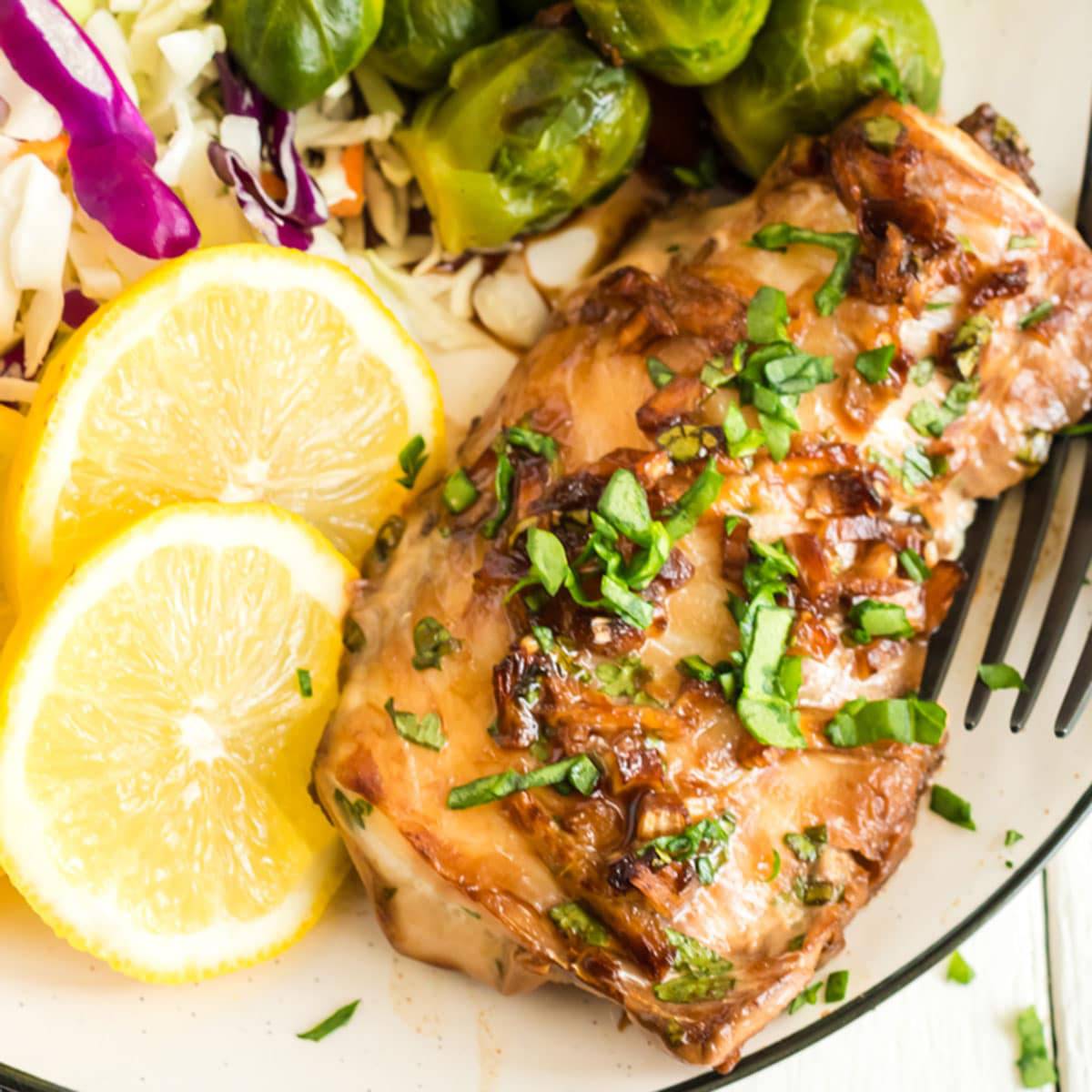 A plate of haddock with Brussels sprouts and lemon slices