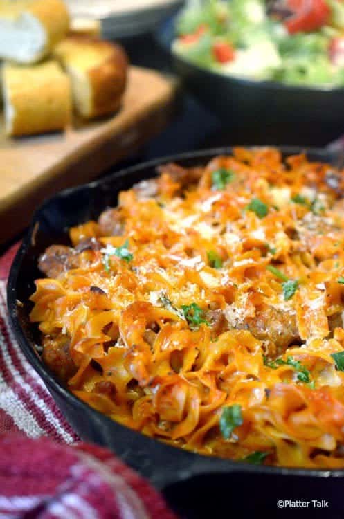 Noodles and sausage in a pan.