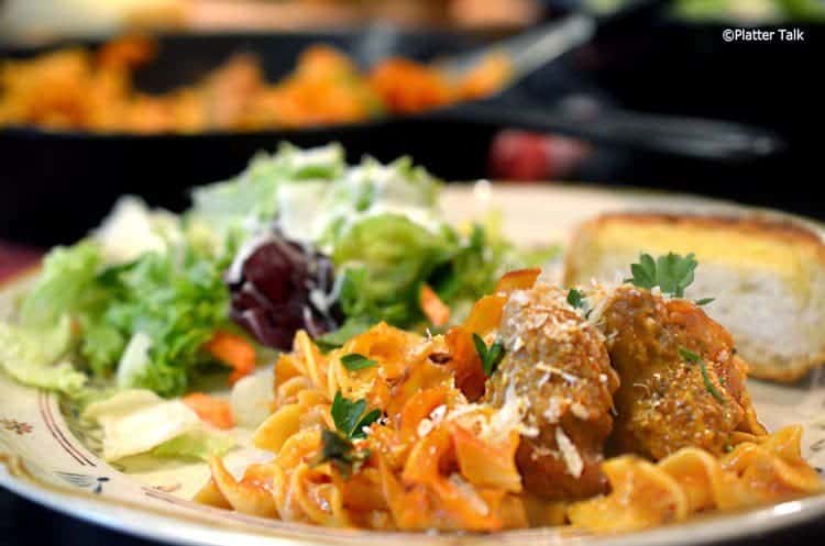 A plate with noodles and salad.