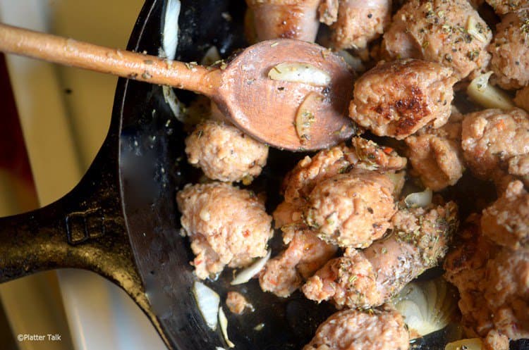 Sausage balls frying in a skillet.