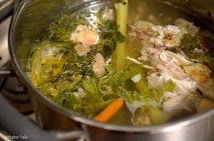 Chicken stock in a stock pan.