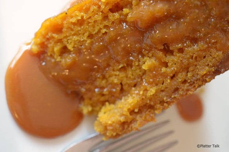 Slice of pumpkin cake with careamel sauce topping.