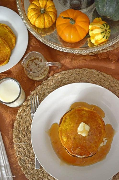 A plate of breakfast food is sitting on a table, with Platter and Pancake