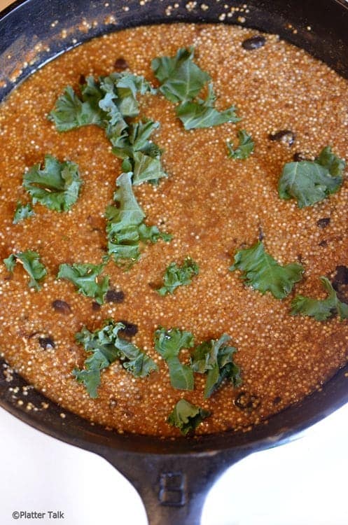 A bowl of quinoa and kale.