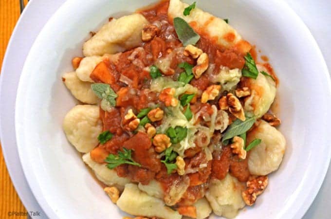 A plate of food, with Gnocchi