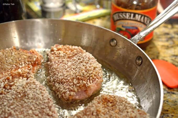 A close up of a metal pan frying food