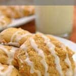 Plate of pumpkin cookies with glass of milk.