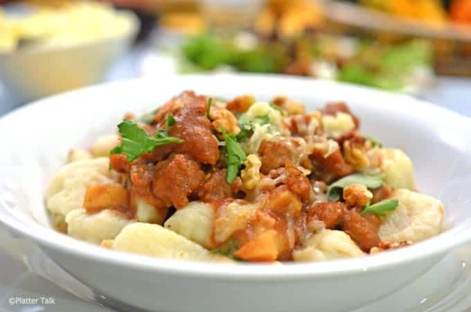 A bowl of food, with Gnocchi and Sauce