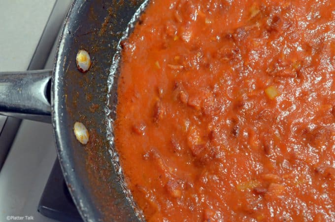 A close up of a metal pan with sauce