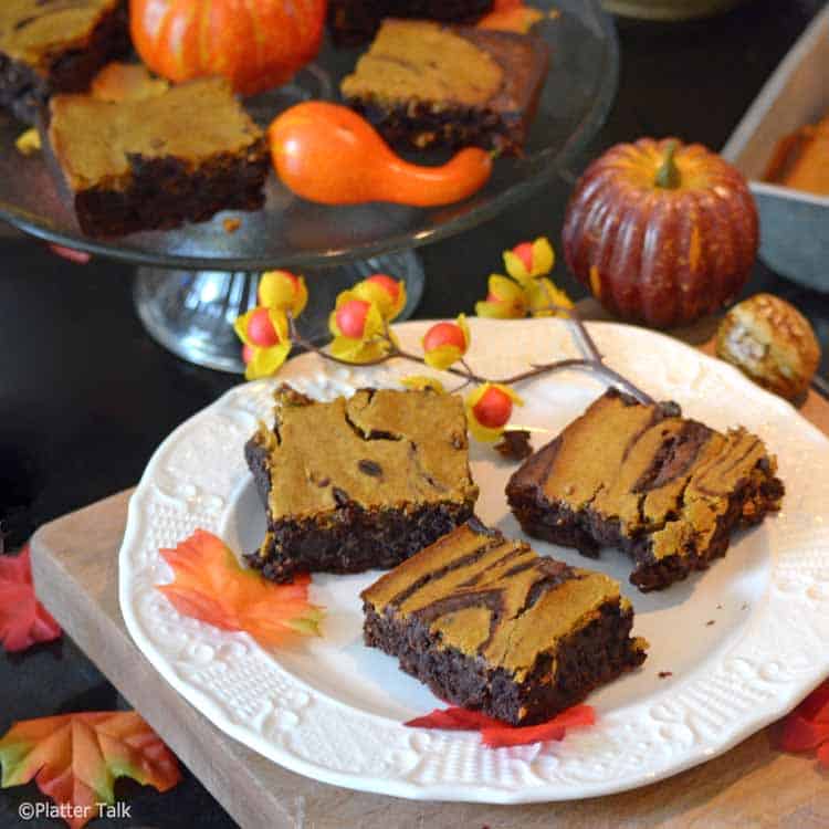 pumpkin cheesecake brownies on a platter.