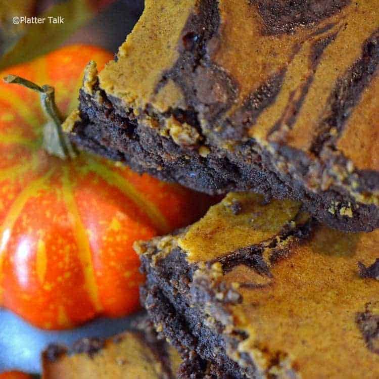 a close up of pumpkin cheesecake brownies.