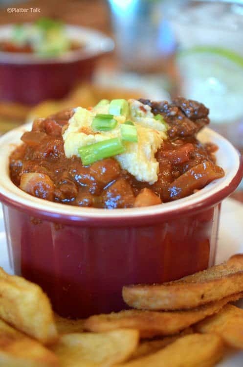 A close-up of a bowl of chili with cheese.