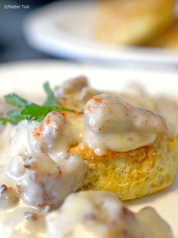 A close up of food on a plate, with Gravy and Biscuits