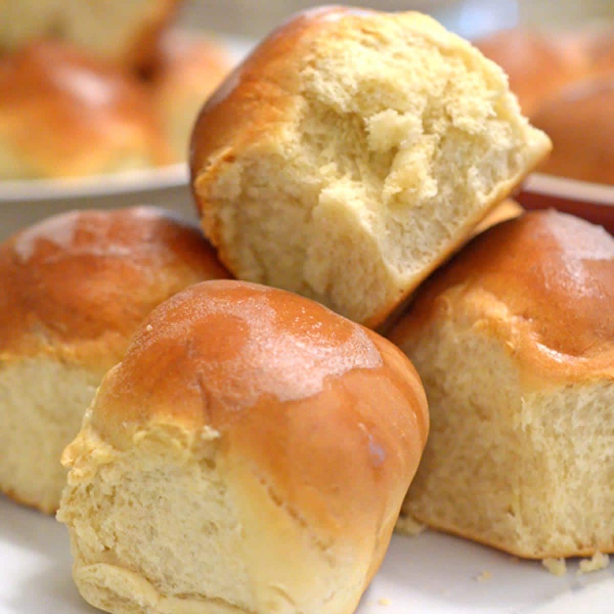 A pile of Thanksgiving rolls on a plate.