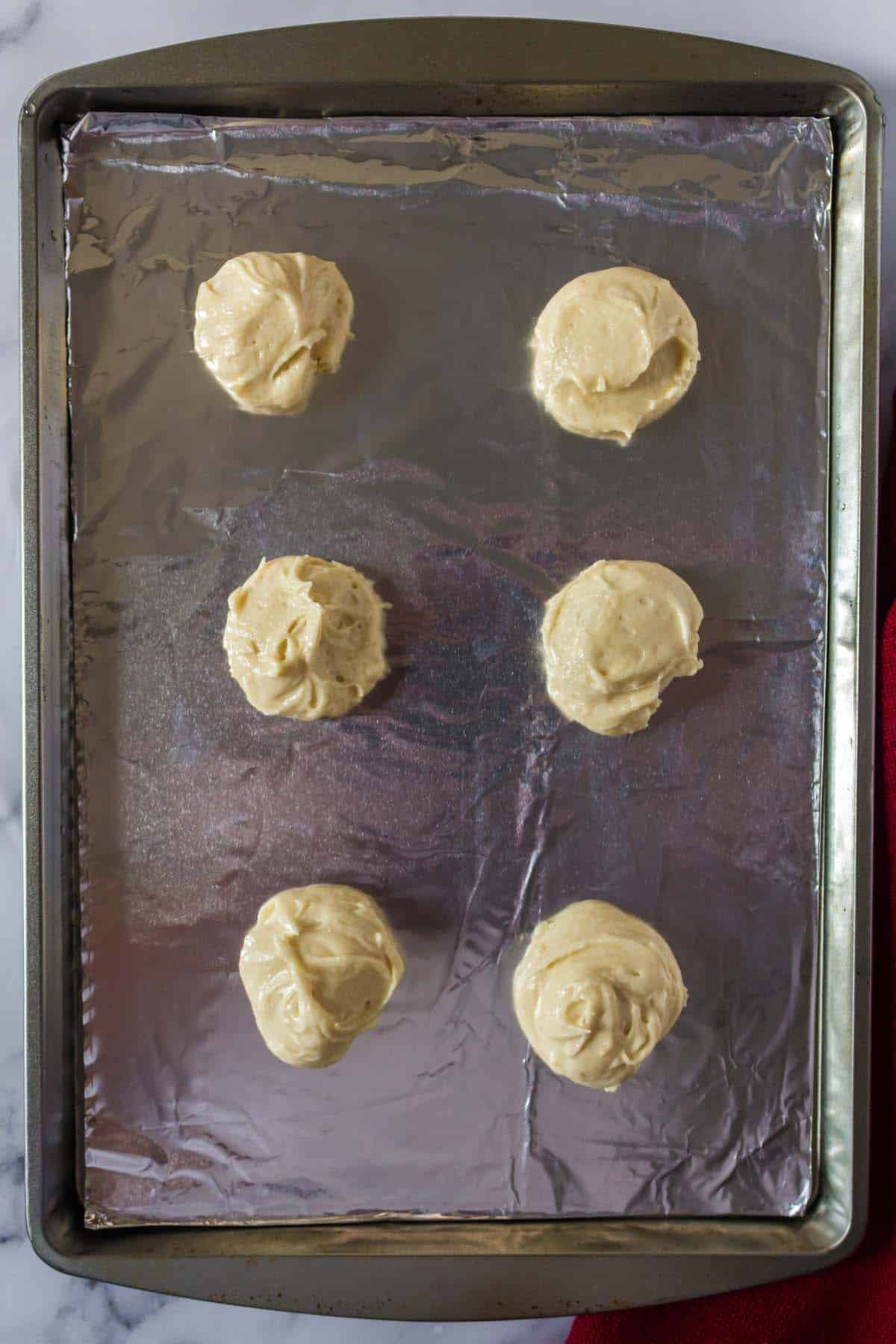Some unbaked cookies on a baking sheet.