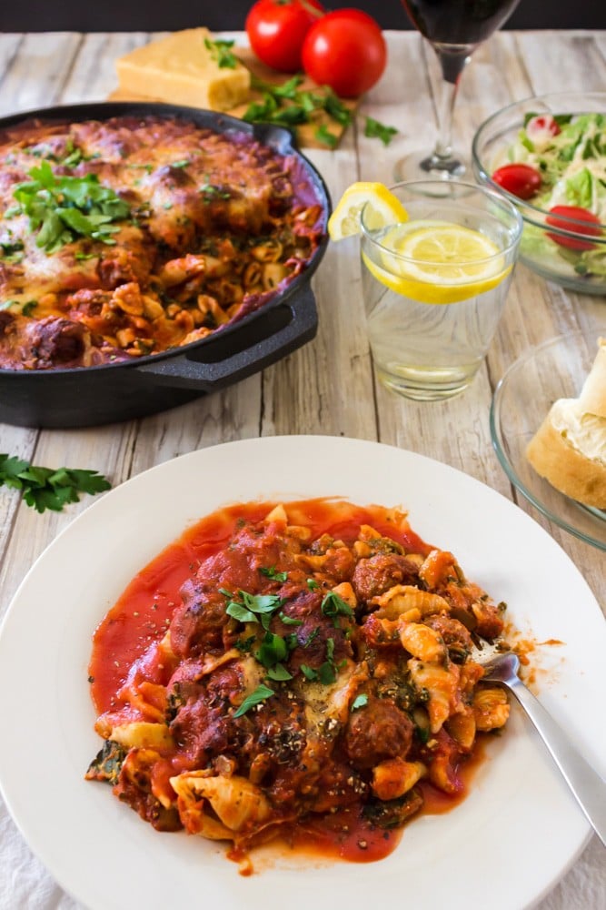 Plate of skillet lasagna with galss of ice water.