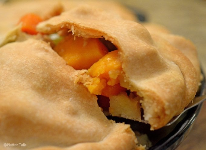 A close up of a pot pie on a plate