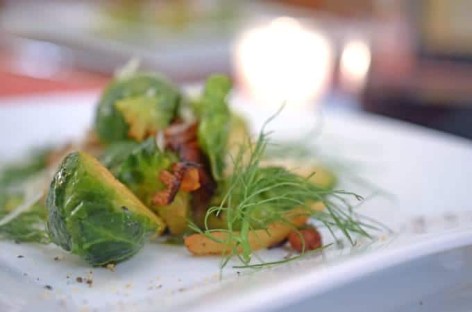 A close up of a plate of salad, with Fennel and Brussels sprout