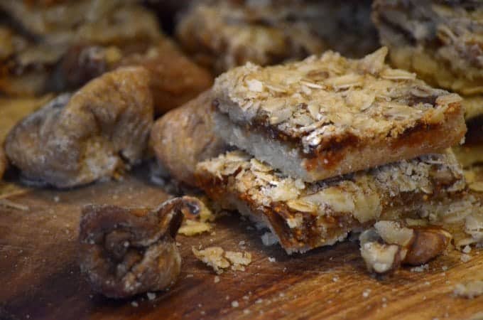 Whole dried figs mixed with cut fig bars on board
