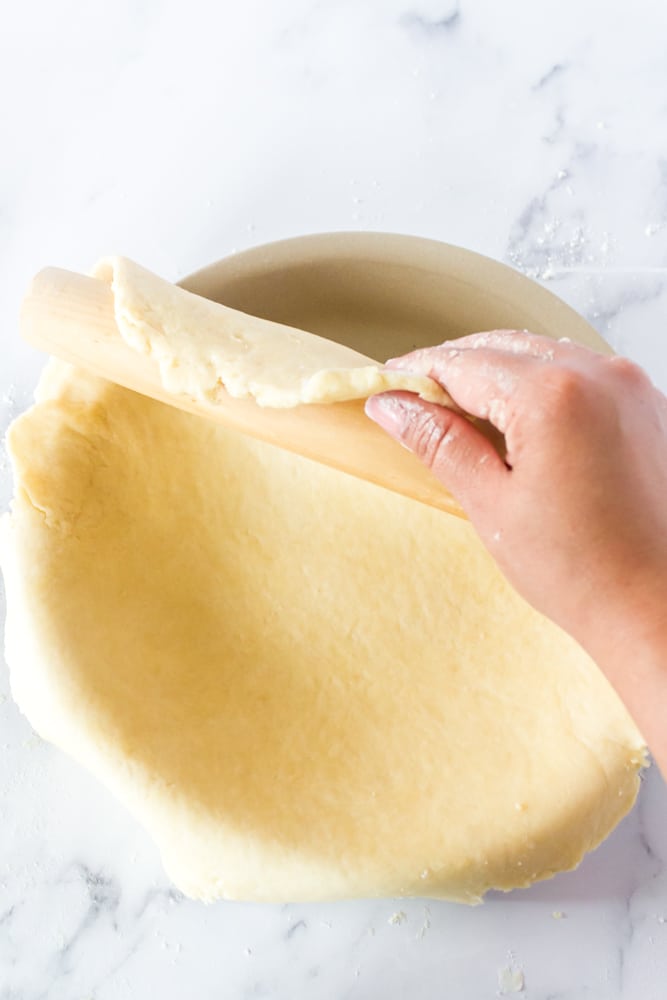Using a rolling pin to roll out a pie crust.