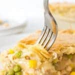 Fork digging into slice of turkey pot pie.