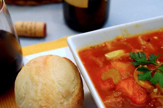 A bowl of food on a table, with Soup