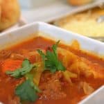 A bowl of food on a tray, with Soup