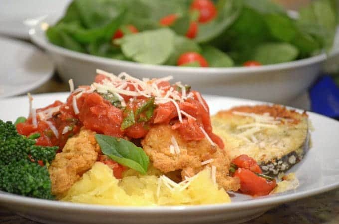 A bowl of food on a plate, with Basil