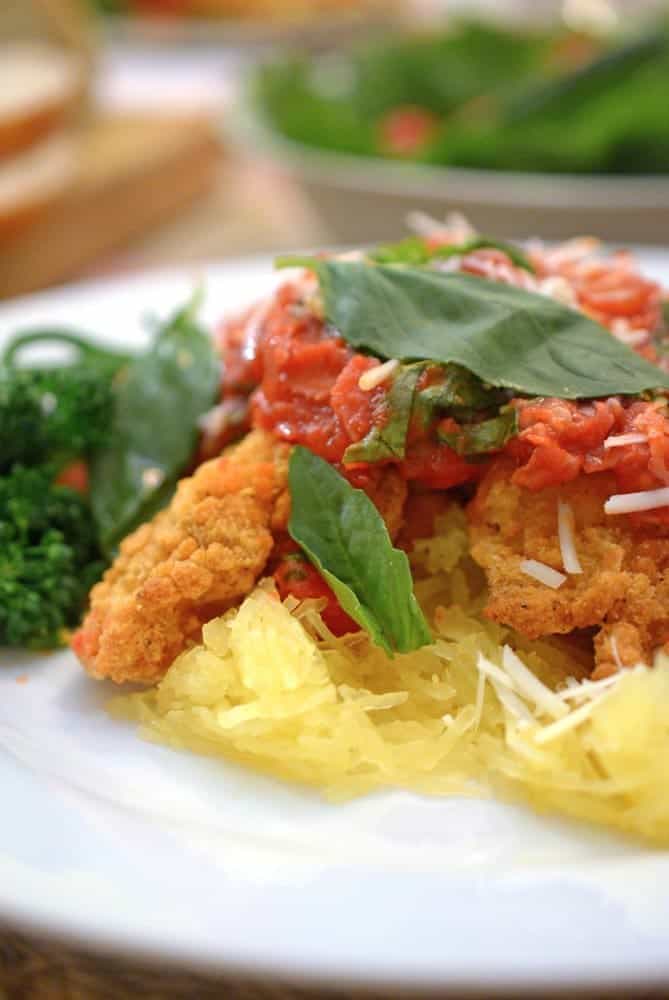 A close up of a plate of food, with Spaghetti and chicken