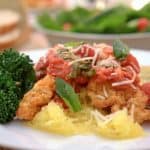 A close up of a plate of food with broccoli, with Basil and Prosciutto