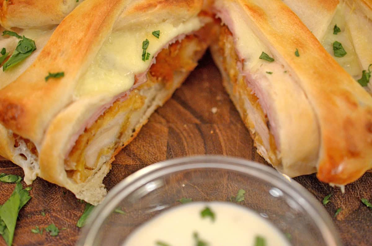 A portion of chicken stromboli cut in half.
