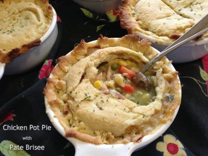 A spoon digging into some chicken potpie.