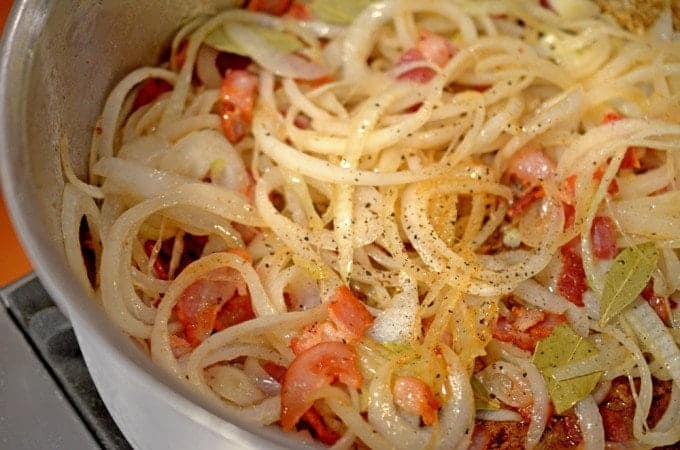 A close up of a bowl of noodles and onion