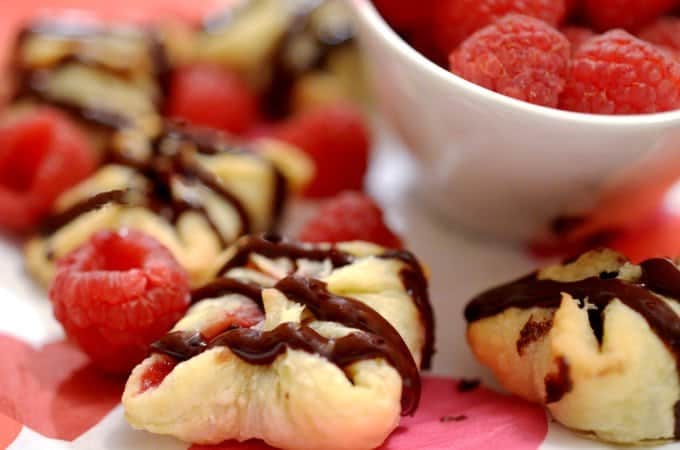 A close-up of dessert, with raspberries and Chocolate.