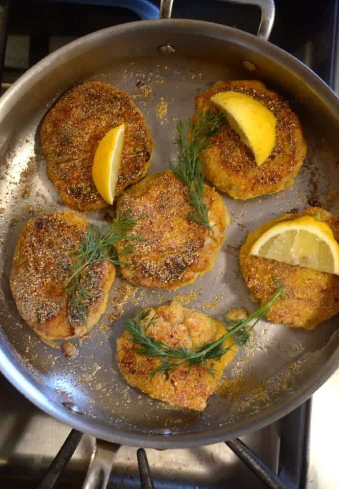 A bunch of fish cakes in a pan.