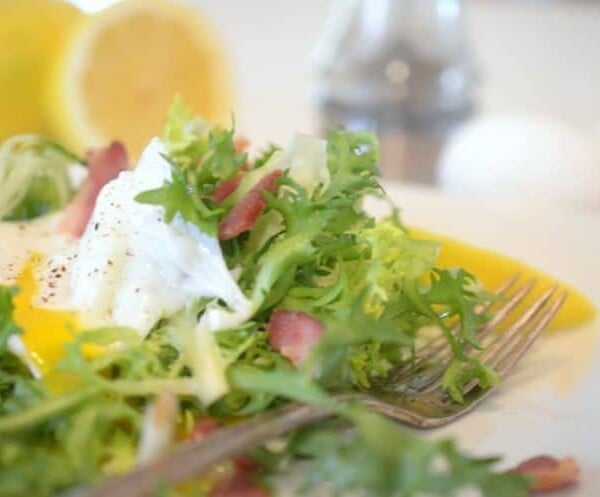 A plate of lettuce and a fork.