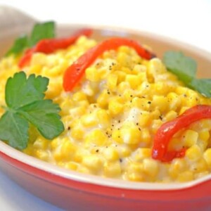 A bowl of corn on a plate.