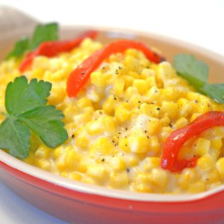 A bowl of corn on a plate.