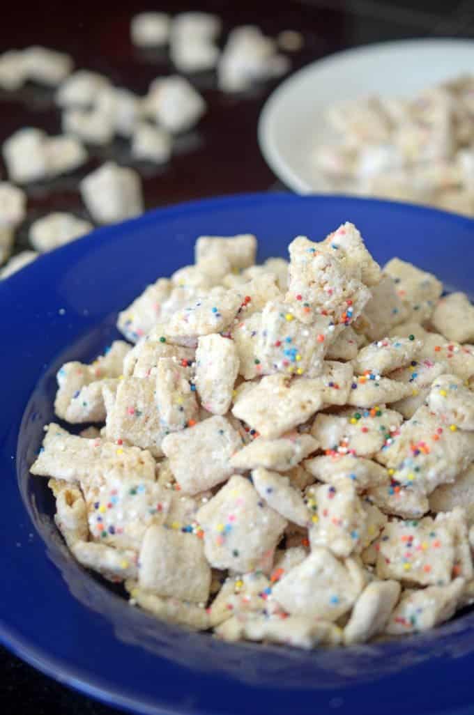 A close-up of a plate of food, with puppy chow snack mix.