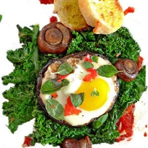 An egg over a ber of kale.