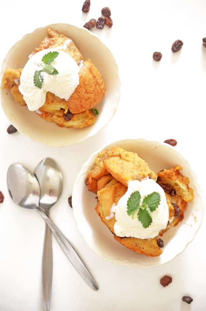 two dishes of slow cooker bread pudding with ice cream.