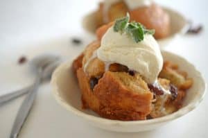 A close up of a bowl of bread pudding.