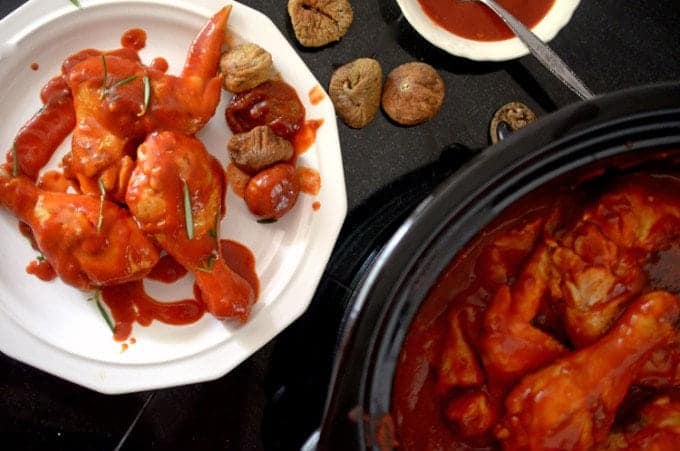 a bunch of chicken wings in a slow cooker